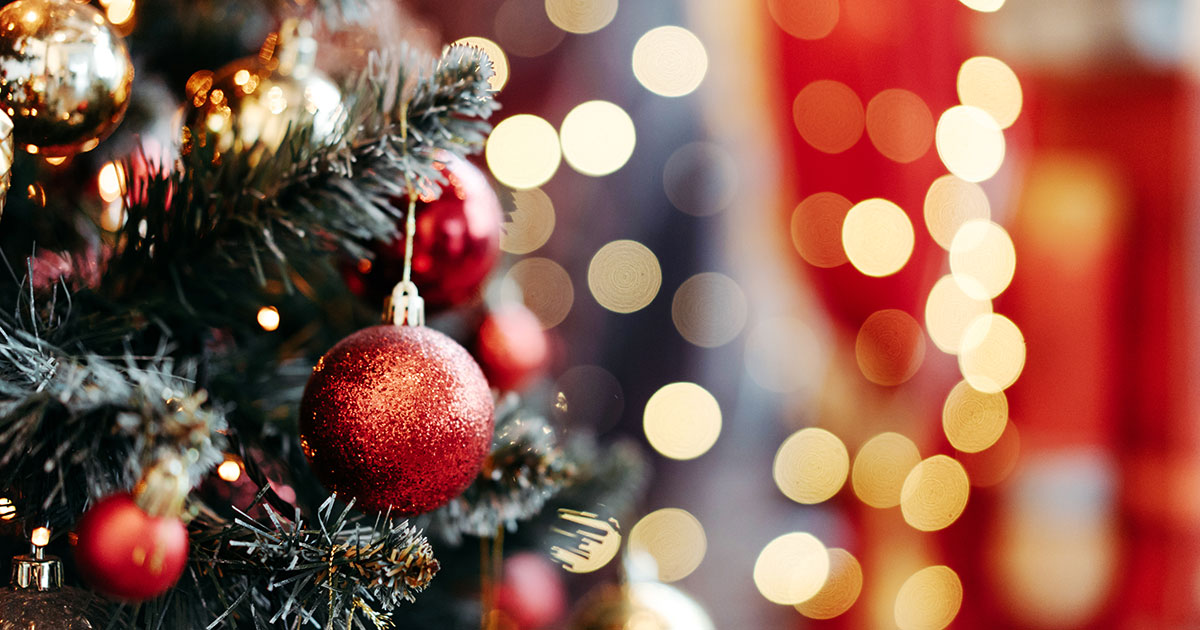 Close up of balls on christmas tree. Bokeh garlands in the background